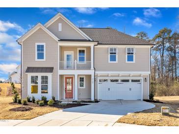 Charming two-story home featuring a cozy balcony, two-car garage, and a neatly landscaped front yard at 3109 Petrea Ct # 39, Angier, NC 27501