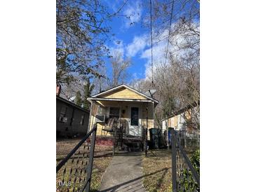 Cute yellow house with front porch and small yard at 603 Bragg St, Raleigh, NC 27610