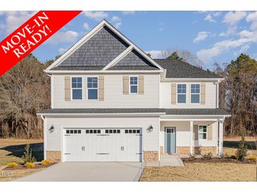 Move-in ready two-story house with a two-car garage and light gray siding at 90 Trescott St, Smithfield, NC 27577