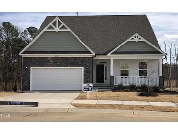Two-story house with gray siding, stone accents, and a front porch at 508 Glenwyck Ct, Fuquay Varina, NC 27526