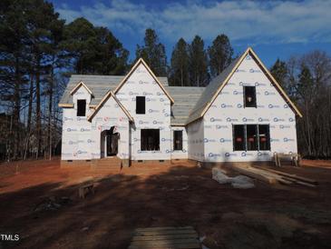 Two-story house under construction, brick exterior, covered porch at 1207 Red Cedar Court, Youngsville, NC 27596