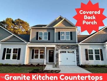 Two-story house with gray siding, stone accents, and a covered porch at 215 Britt St, Smithfield, NC 27577