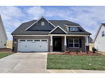 Beautiful single-story brick home featuring a two-car garage and inviting front porch at 1056 Fairhaven Dr # 97, Mebane, NC 27302
