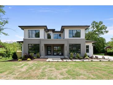 Stunning modern home featuring a unique facade, manicured lawn, and ample natural light at 712 Daniels St, Raleigh, NC 27605