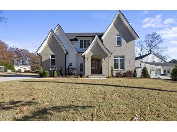 Charming two-story home with gray brick, stylish gables, and a welcoming front entrance at 701 Dartmouth Rd, Raleigh, NC 27609