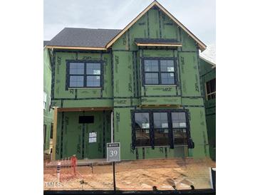 Two-story home under construction with visible ZIP system sheathing and dark framed windows at 2408 Adrift Road, Fuquay Varina, NC 27526