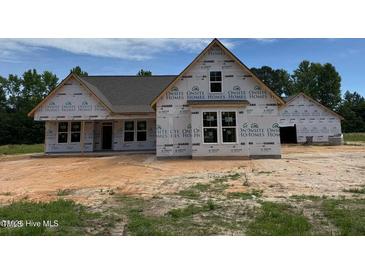 Exterior of new home construction, with OSB and housewrap, featuring attached garage at 375 Graham Rd, Cameron, NC 28326
