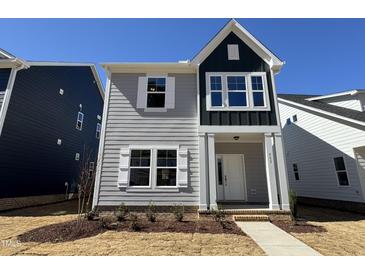 Charming two-story home featuring a blend of gray and dark siding and a well-manicured front lawn at 757 Portland Rose Dr, Knightdale, NC 27545