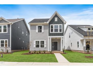 Charming two-story home with gray siding, white trim, and a well-manicured lawn at 757 Portland Rose Dr, Knightdale, NC 27545