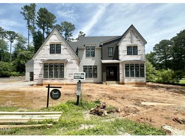 New construction home featuring a modern design with a neutral color palette and large windows at 7000 North Ridge Dr, Raleigh, NC 27615