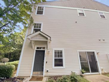 Charming townhouse with neutral siding, black front door, and well-maintained landscaping at 330 Gilman Ln # 106, Raleigh, NC 27610