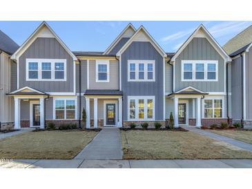 Charming townhomes with varied color schemes, well-manicured lawns, and inviting front entrances at 3181 Mission Olive Pl # 346, New Hill, NC 27562