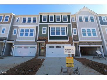 Three-story townhome with two-car garage and neutral color palette at 2337 Bay Minette Sta # 553, Apex, NC 27502