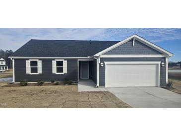 Charming single Gathering home featuring a two car garage, white trim, and dark siding at 566 John Stark Dr, Fuquay Varina, NC 27526