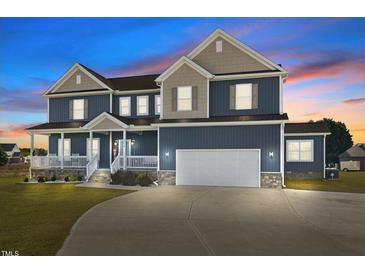 Beautiful two-story home featuring a covered front porch and an attached two-car garage at 5554 Lake Vista Ct, Rocky Mount, NC 27803