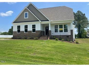 Charming two-story home with brick accents and a well-manicured lawn in a peaceful, friendly neighborhood at 52 Quail Point Cir, Clayton, NC 27520