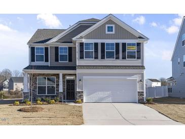 Two-story house with gray siding, white trim, and a two-car garage at 1019 Gibson House Dr, Burlington, NC 27215