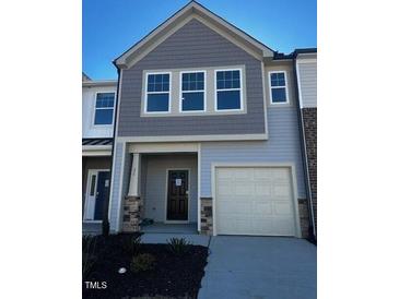 Two-story townhome with gray siding, attached garage, and landscaping at 26 Clementine Street St # 205, Angier, NC 27501