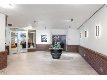 Elegant building lobby with tile floors, modern lighting, and stylish decor creating an inviting entrance at 222 Glenwood Ave # 508, Raleigh, NC 27603