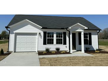 Charming single-story home featuring a white facade, black shutters, and a well-manicured lawn at 111 Johnson Ridge Way, Four Oaks, NC 27524