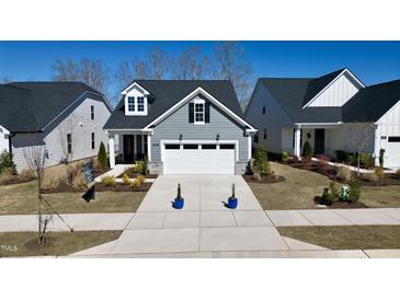 Charming home with a two-car garage, grey siding, and a well-manicured front yard at 2281 Abbeyhill Dr # 136, Raleigh, NC 27610