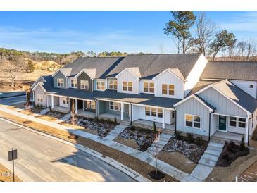 New townhouses with gray and green exterior, front porches, and landscaping at 3939 Willow Gate Way, Knightdale, NC 27604