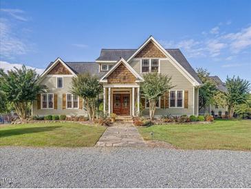 Charming two-story home with manicured lawn, stone walkway, and inviting double door entry at 548 Double N Rd, Pittsboro, NC 27312