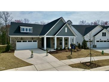 Charming single-story home features a brick facade, gray siding, and a well-manicured lawn at 2209 Abbeyhill Dr # 118, Raleigh, NC 27610