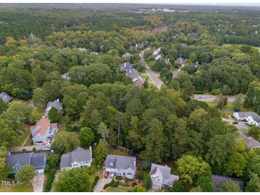 Beautiful aerial view of a neighborhood surrounded by lush green trees and winding roads at 416 Englewood Dr, Chapel Hill, NC 27514