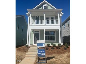 Charming two-story home with inviting front porch and manicured front yard at 707 Georgias Landing Pkwy # 105, Raleigh, NC 27603