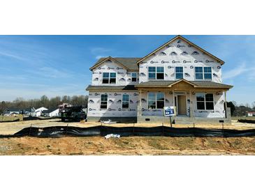 Two story new construction home with visible house wrap and window openings at 111 Demascus Way # 021, Four Oaks, NC 27524
