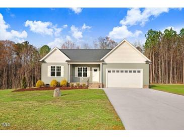 Charming single-story home with a two-car garage, well-maintained lawn, and inviting front entrance at 9314 Turkey Way, Middlesex, NC 27557