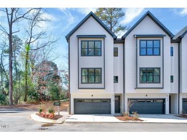 Charming townhome with a modern design, gray trim and a spacious two-car garage at 811 Maple Berry Ln # 106, Raleigh, NC 27607