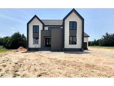 Striking two-story home featuring modern architectural design and a beautifully landscaped yard at 280 Forest Bridge Rd, Franklinton, NC 27525