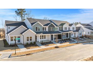 New townhome development showcasing modern farmhouse exteriors and landscaping at 3929 Willow Gate Way, Raleigh, NC 27604