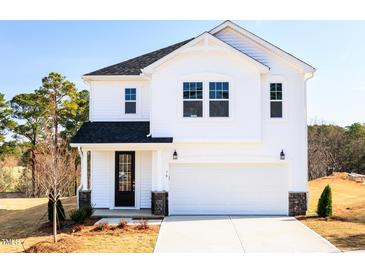 New two-story home with white siding, black door, and a two-car garage at 70 Little Creek Dr, Lillington, NC 27546