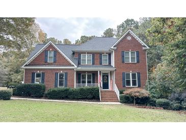Two-story brick home with landscaped lawn and porch at 159 Trantham Trl, Clayton, NC 27527
