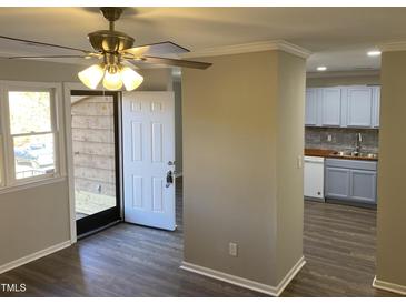 Bright entryway with wood floors and view into updated kitchen at 501 Kendall Dr, Durham, NC 27703