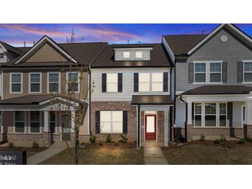 Charming two-story home with a brick facade and inviting red front door at 955 Alma Railway Dr # 563, Wake Forest, NC 27587