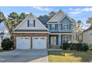 Inviting two-story home with a stone facade and attached two-car garage at 98 Valley Brook Ln, Spring Lake, NC 28390