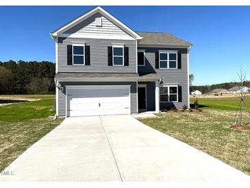 Two story home with gray siding, black shutters and a two car garage on a sunny day at 158 Citizens Ct # 32, Four Oaks, NC 27524