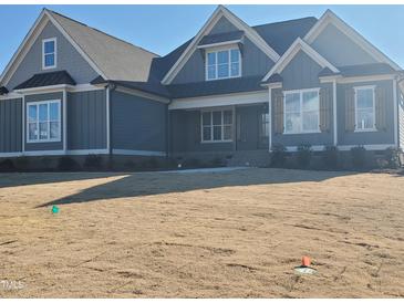 Charming home with a well-manicured lawn and inviting architectural details at 70 Water Willow Ln, Zebulon, NC 27597