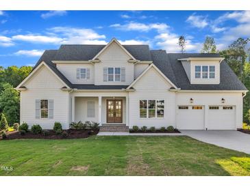 Beautiful two-story home with a well-manicured lawn and attached two car garage at 27 Asti Ct, Clayton, NC 27527