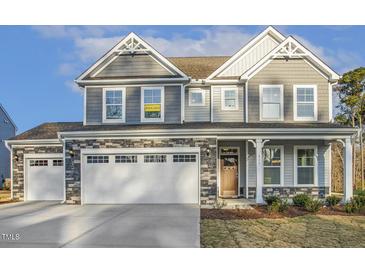 Beautiful two-story home with stone accents, attached garage, and manicured lawn at 611 Highview Dr, Benson, NC 27504