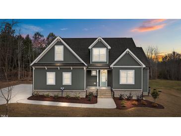 Two-story craftsman home with gray siding, landscaping, and a light gray door at 25 Basil Ct, Franklinton, NC 27525