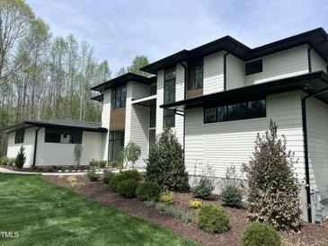 Stunning contemporary home featuring modern design and manicured landscaping at 196 Mountaintop Cir, Pittsboro, NC 27312