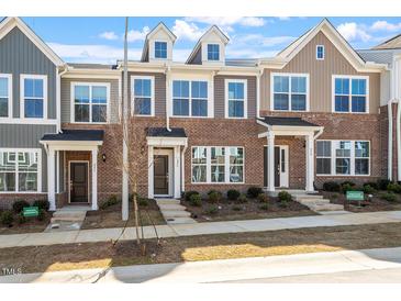 Charming townhomes showcase brick and siding exteriors, complemented by manicured landscaping and inviting entryways at 255 Chesapeake Commons St # 90, Garner, NC 27529