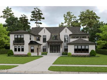 Magnificent home featuring a light brick exterior, dark-trimmed windows, complemented by mature landscaping and a concrete driveway at 216 Dartmouth Rd, Raleigh, NC 27609