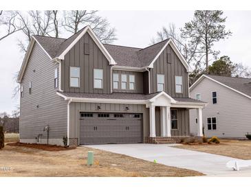 Charming two-story home with gray siding, white trim, and a two-car garage at 2401 Terri Creek N Dr # 08, Fuquay Varina, NC 27526