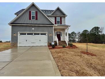 Charming two-story home featuring a two-car garage and beautiful, newly installed landscaping at 95 Mapledale Ct, Benson, NC 27504